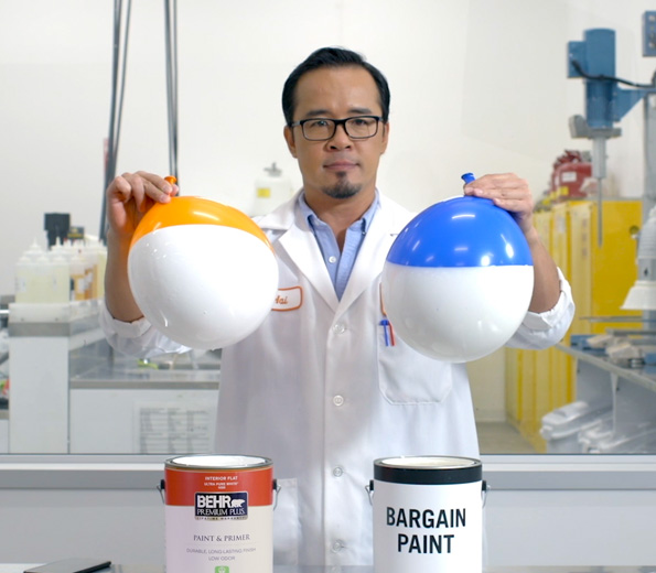 A Behr employee in a lab coat showing the balloon test
