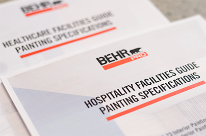 Image of a BEHR PRO Hospitality Guide Painting Specifications and Healthcare Facilities Guide Painting Specifications documents on a terrazzo surface.