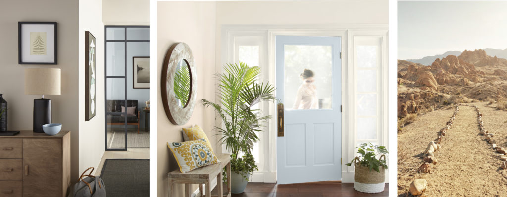 A hallway showing a peak of a iving room and an entry way. Both rooms the walls are painted in a light, almost white neutral color.