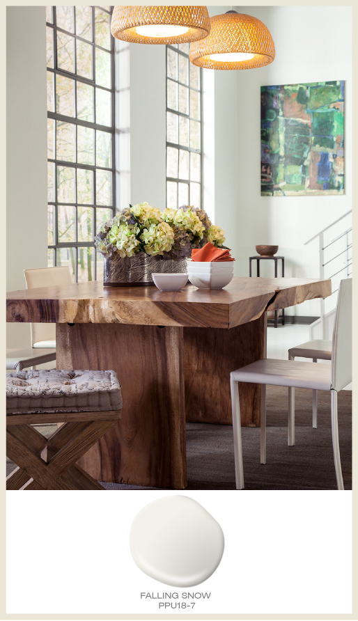 A modern loft dining area featuring natural toned dining table and seating stool.