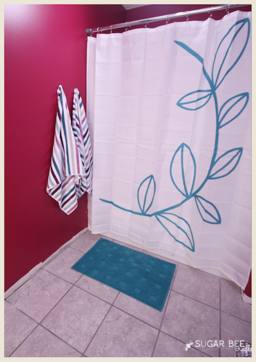 A sneak peek of a bathroom painted in a cranberry color.