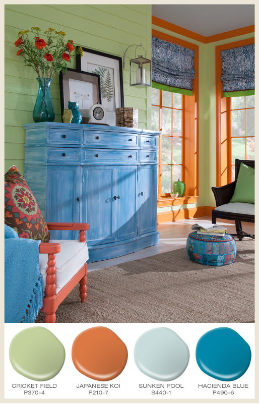 A green paneled sun-room with bright orange window trim and blue accents.