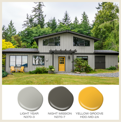 A tone on tone gray house with bright  yellow door.