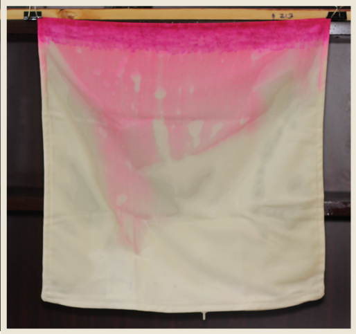 A pillow case with dispersing dye starting to create an ombre look.
