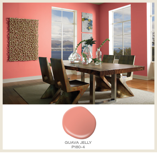 A modern dining room featuring coral pink walls.