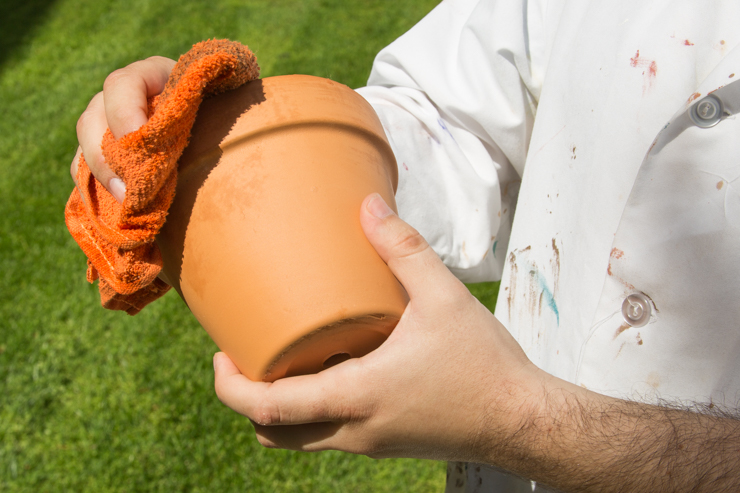 Cleaning a clay pot.