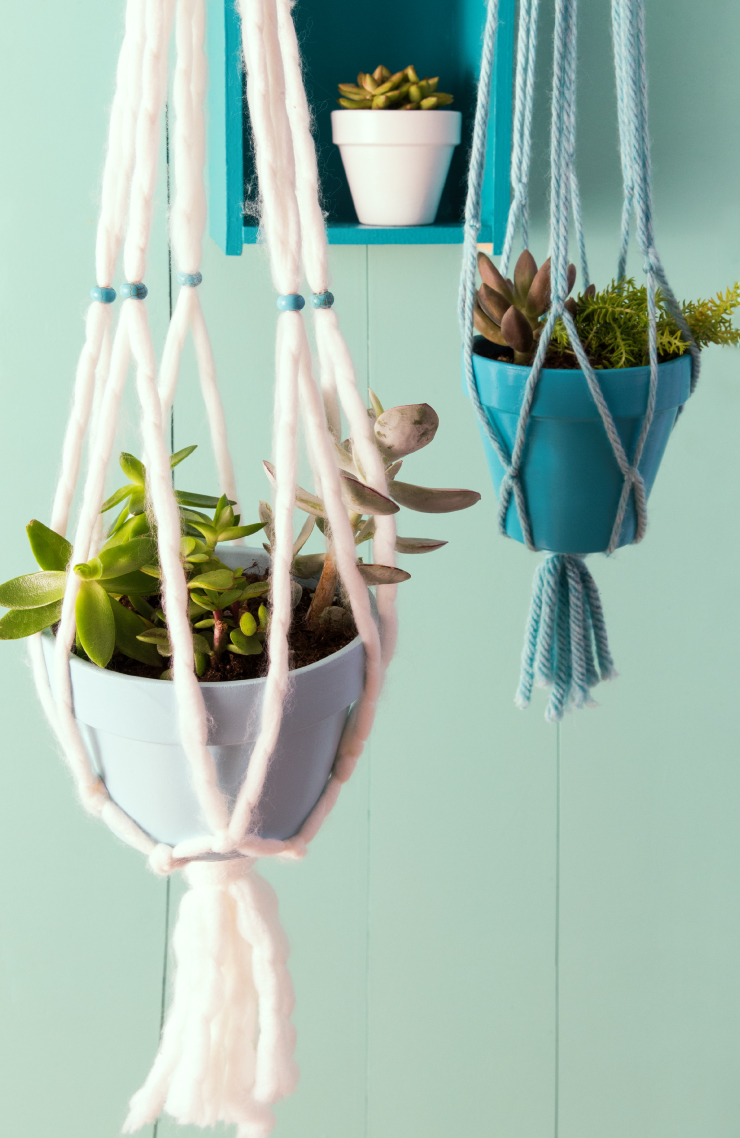Hanging flower pots painted in white and blue. 