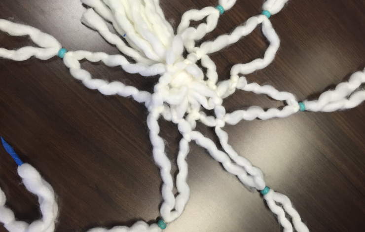 Beads added to white yarn.