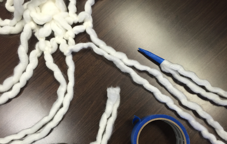 White yarn with ends taped.