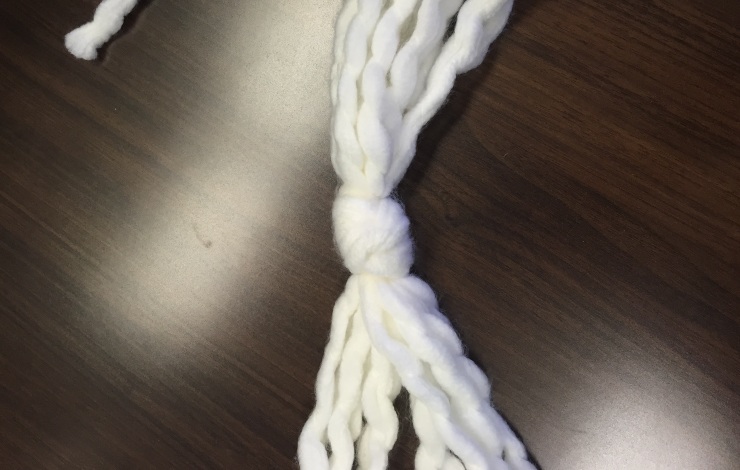Yarn strands with a knot tying them together.