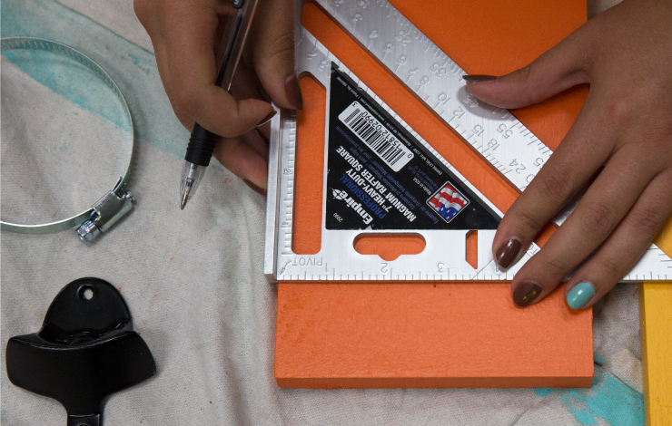 measuring the orange painted board.