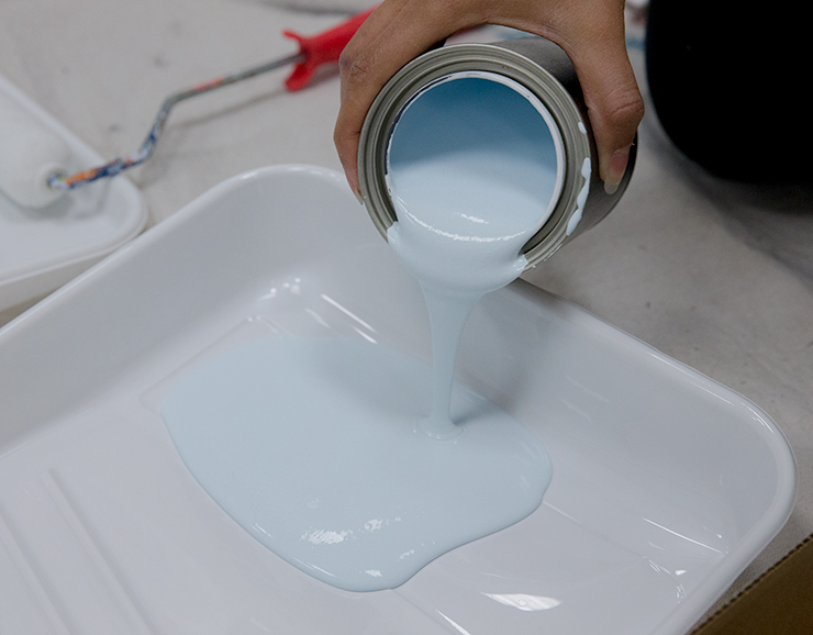 pouring paint into a paint tray
