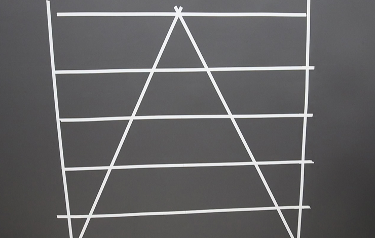 Adding white painter's tape on the wall in the shape of the geometric pattern.
