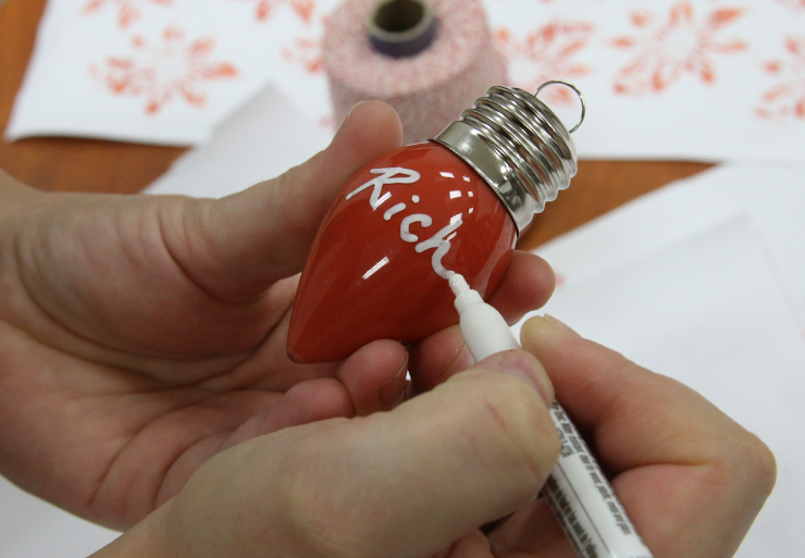 using a paint pen to write on ornament