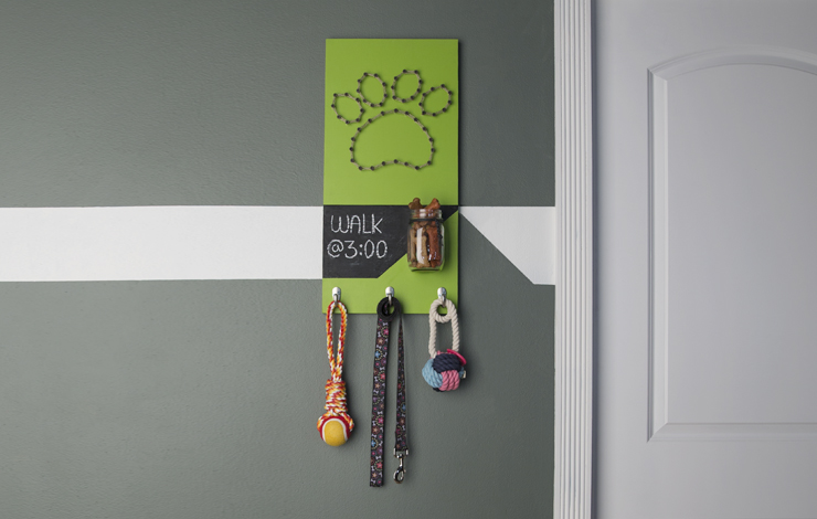 Dog leash holder placed on wall in entryway.