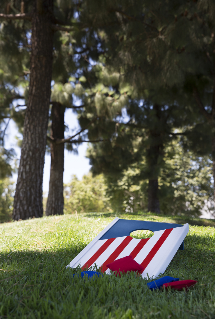 Finished game board placed on a grassy ground set up to play corn hole.
