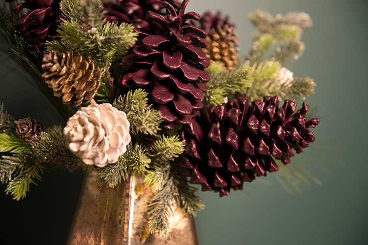The finished project is pinecones with branches of pine needles decorated in a beautiful bouquet. 