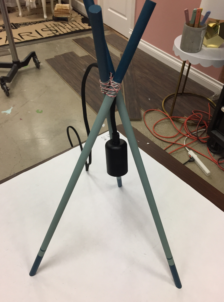  Showing the base of the tripod lamp standing up.