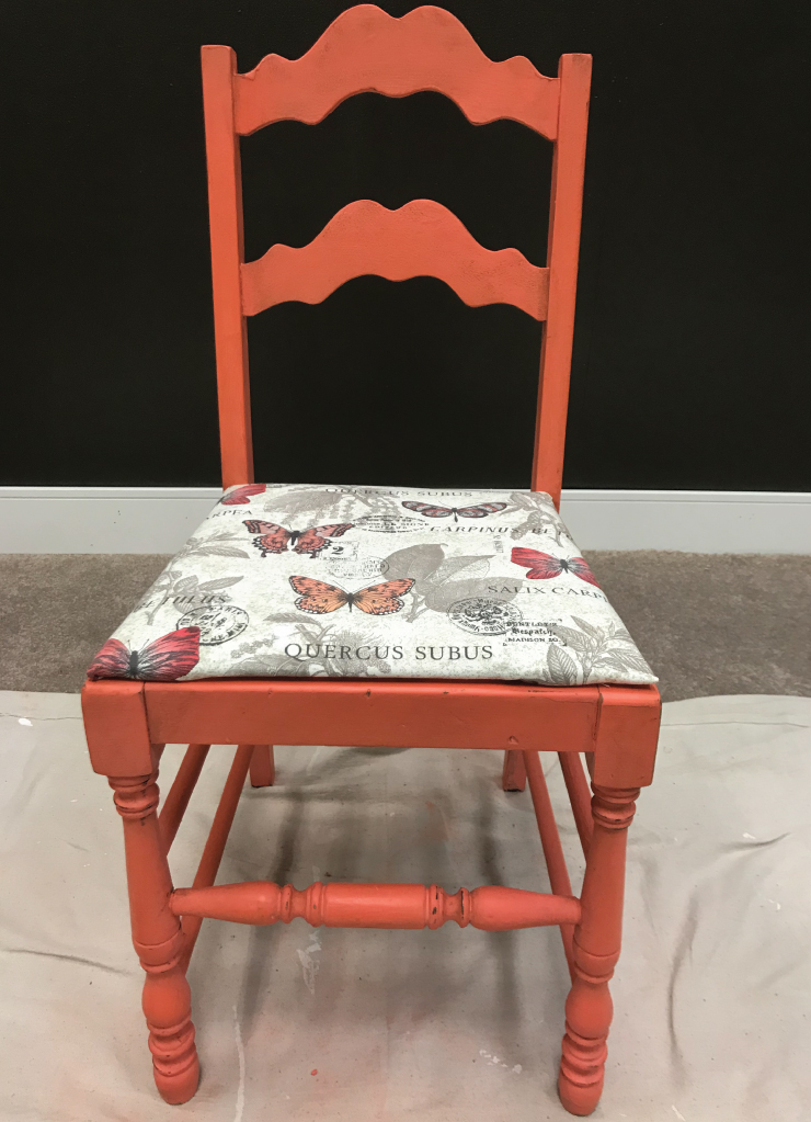 An after shot of an old chair after it's been made over with paint, wax and new fabric. 