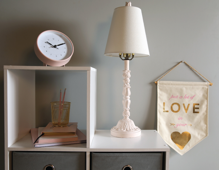 Cube shelves with decorative items such lamp, clock, notebooks, pencils and pencil holder.  
