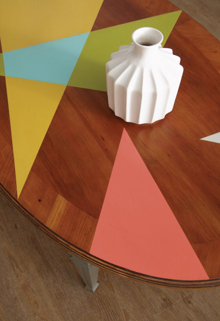 A table with triangle shapes painted in multiple colors.