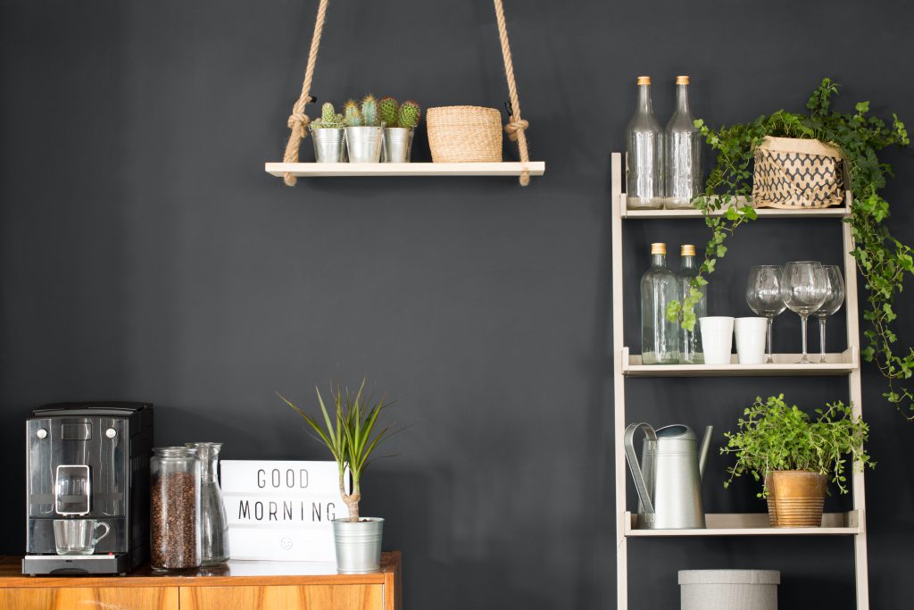 Modern kitchen with matte dark gray, swing shelf and ladder bookshelf.  A wall painted with dark gray color, Graphic Charcoal. 