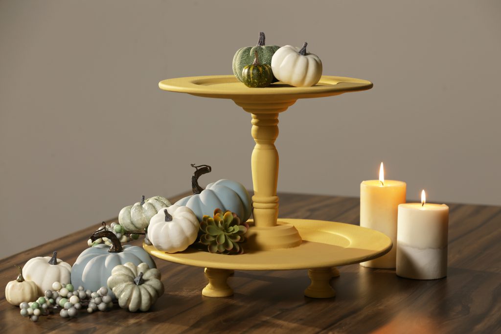Finished tier decorated with pumpkins on a wood table. 