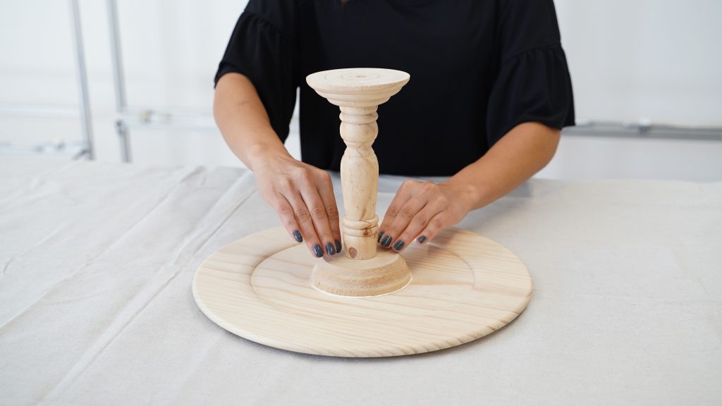 Gluing candle stick to tray.