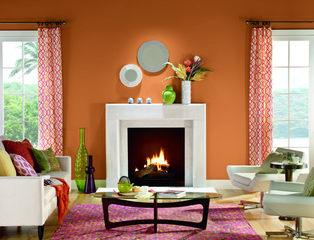 A modern-tropical style living room, wall is painted in orange color called Rumba Orange.