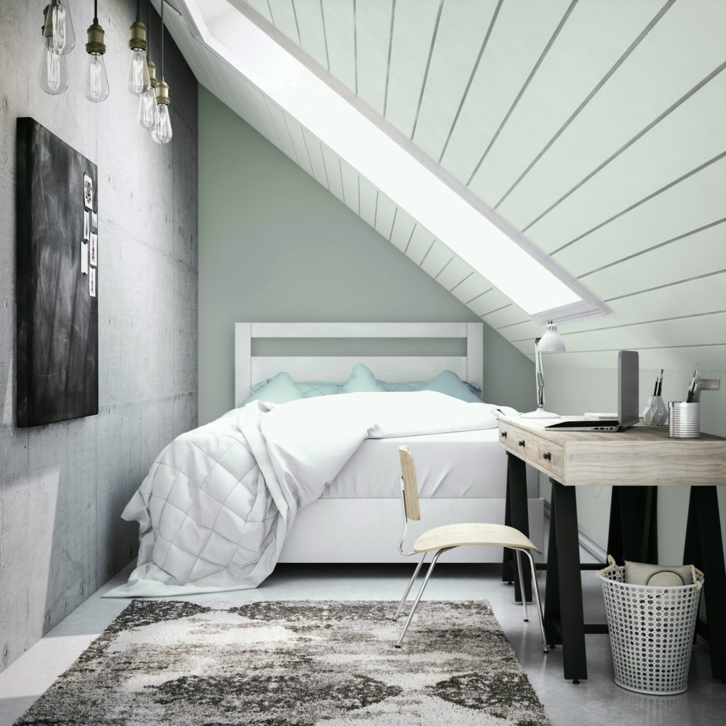 A bedroom with a low slanted ceiling