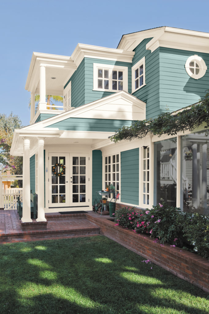 A two story transitional home, the structure is covered in siding painted in blue color called Dragonfly.