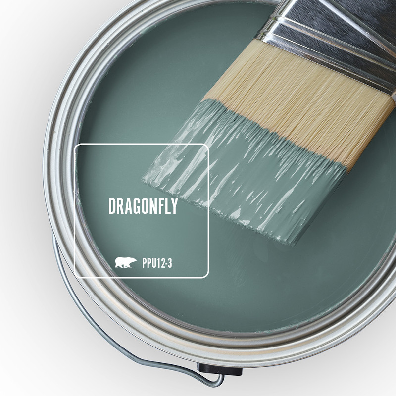 The top view of an open paint can and paint brush. 