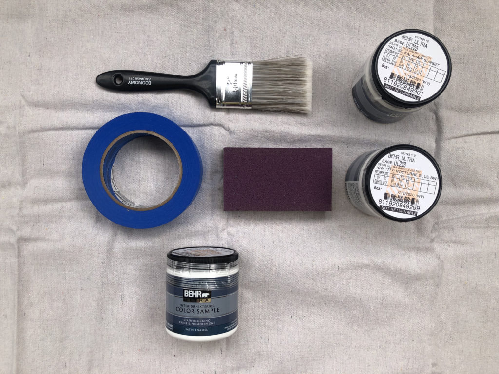 This image shows the products used for this project. 
A paint brush.
Painters Tape.
Sanding Block.
And three 8 oz. samples.