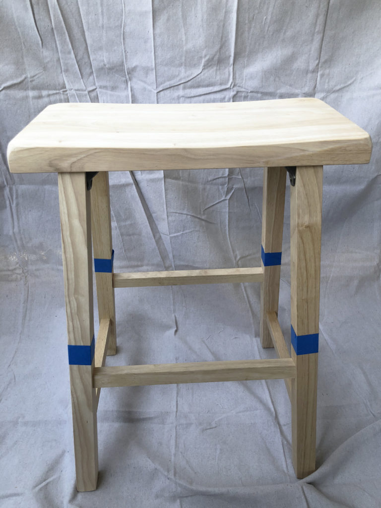 First this is the bare wooden stool that was taped off in the areas I wanted to paint. 