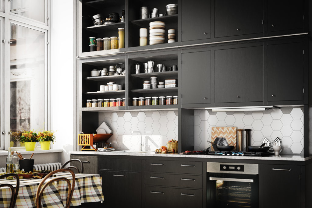 A Scandinavian style kitchen with trendy black cabinets. The matte finish on the black cabinets creates elegance and depth to the room.