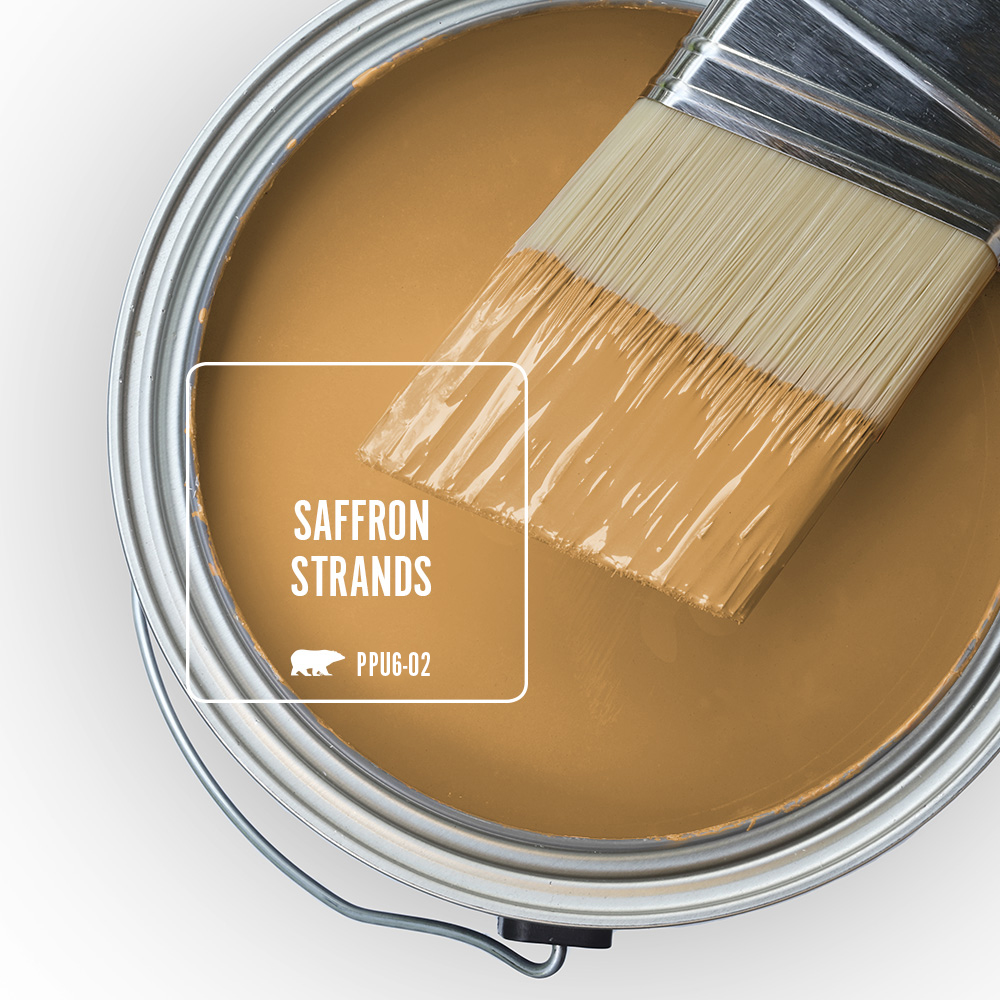 The top view of an open paint can, featuring to a yellow color called Saffron Strands. 