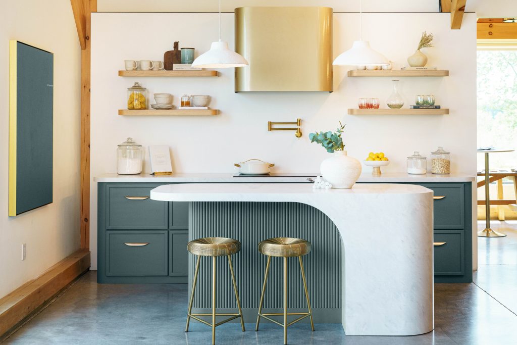 A kitchen painted in a deep jade hue.