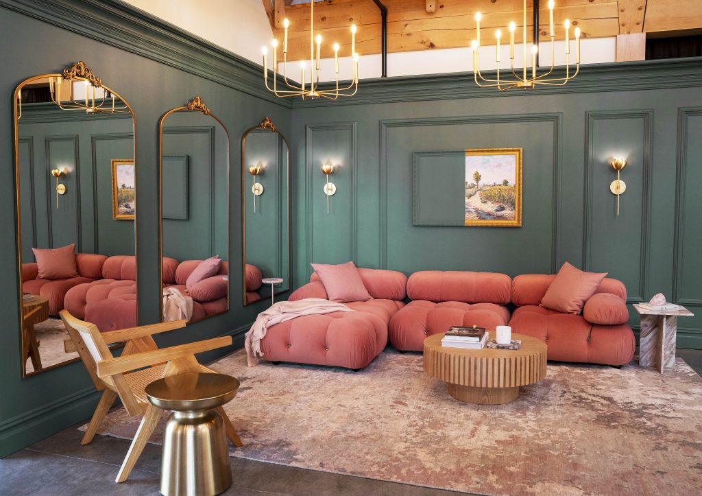 A plush livinging room painted in a deep jade hue.