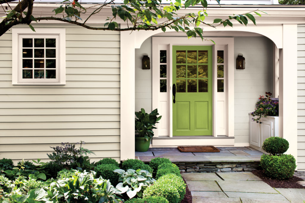 A house with a bright green painted front door.