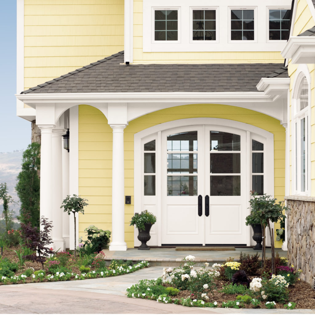 A yellow painted house with a white front door.