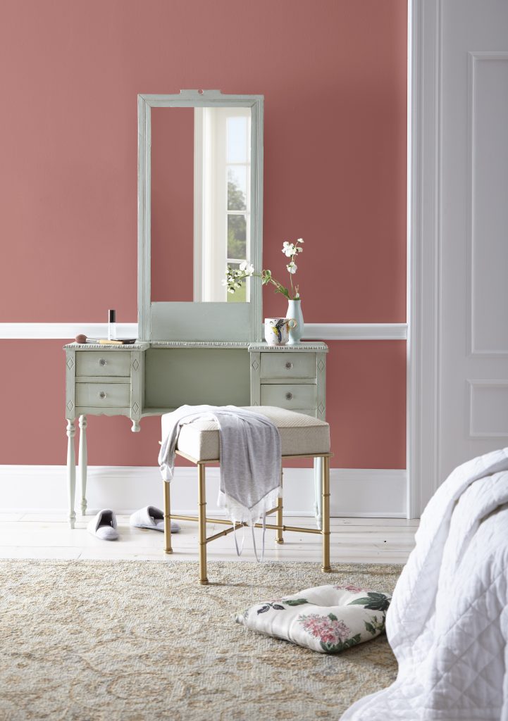 A make-up area showing the walls in a muted red hue.