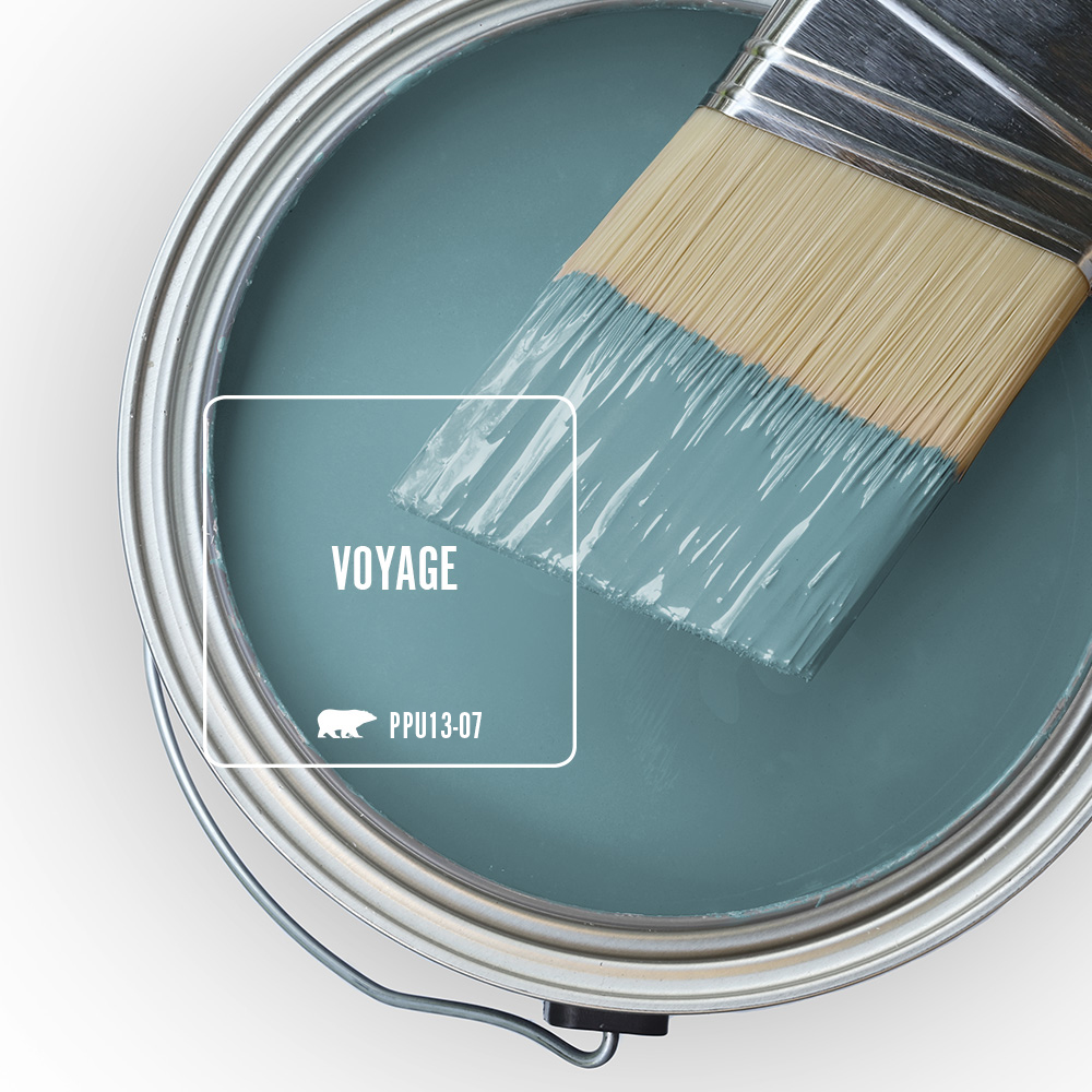 An open can overview with a halpf dipped paint blue, the featured blue color is called voyage. 