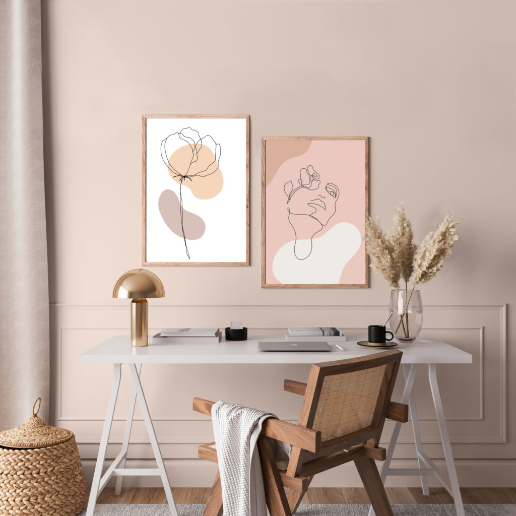 A Scandinavian interior. there is  rattan chair and white desk in home office room design.  The wall is painted in a light dusty pink color called Seaside Villa. 