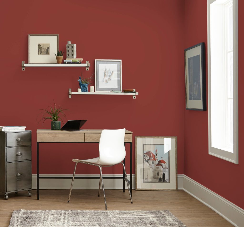 A casual eclectic home office space, the walls are painted in a popular, deep red color called Red Pepper. 