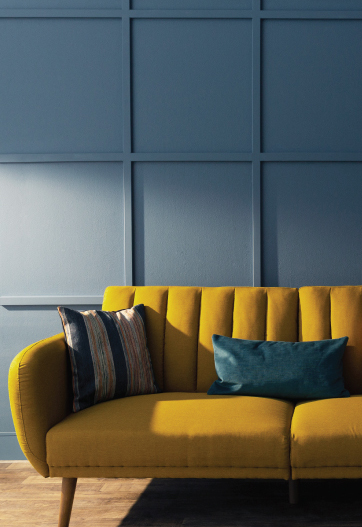 A living room with a decorative wall painted in blue.