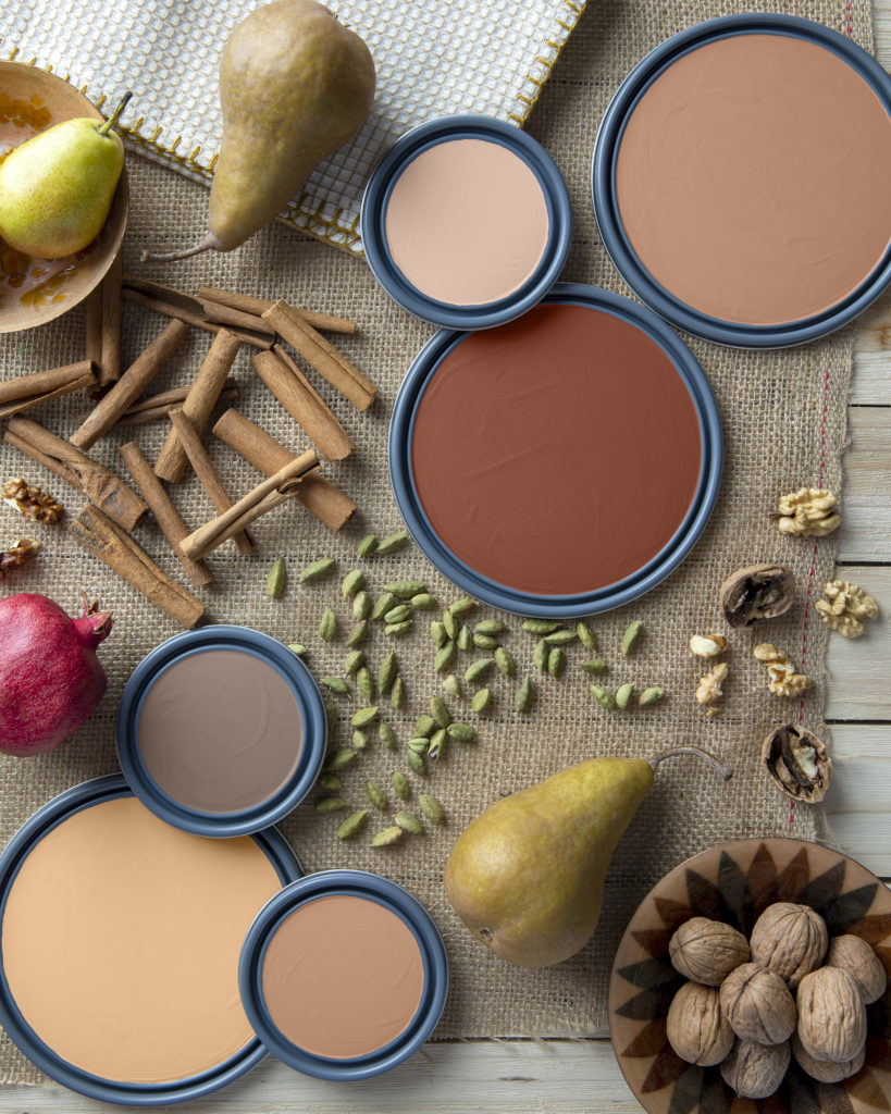 A collage of pain lids in browns and creams surrounded by fruits and spices.