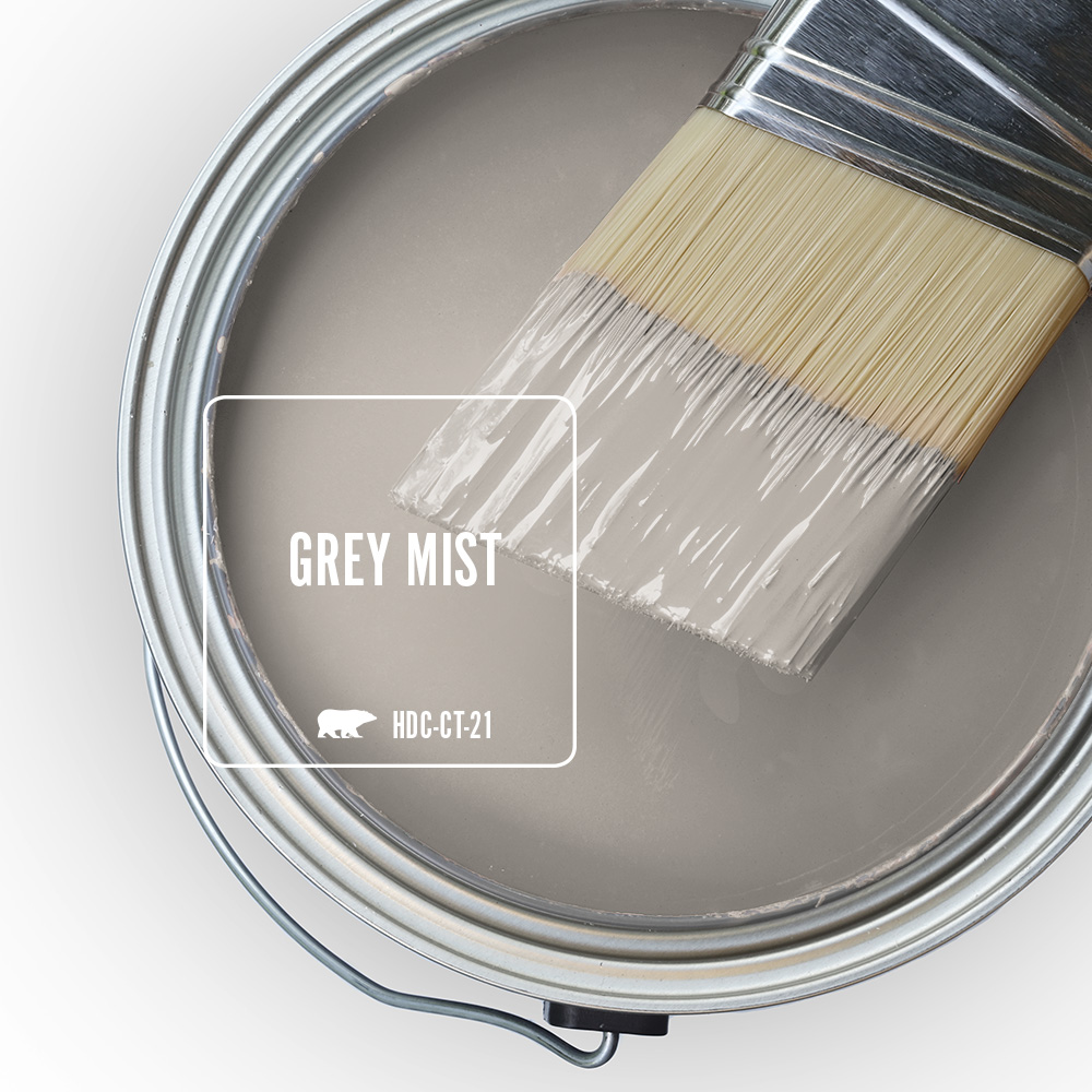 An open paint can showing a grey color inside.