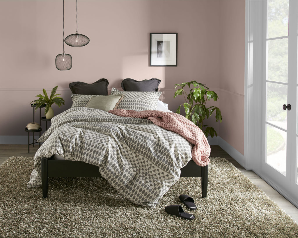 Bedroom image in a warm brown tone with rosy undertones. 