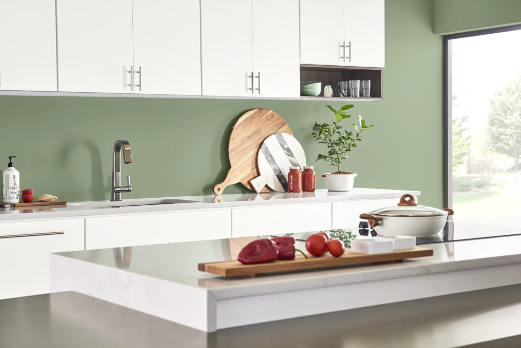 A modern-casual kitchen with white cabinets.  The backsplash paint color called Laurel Tree. 