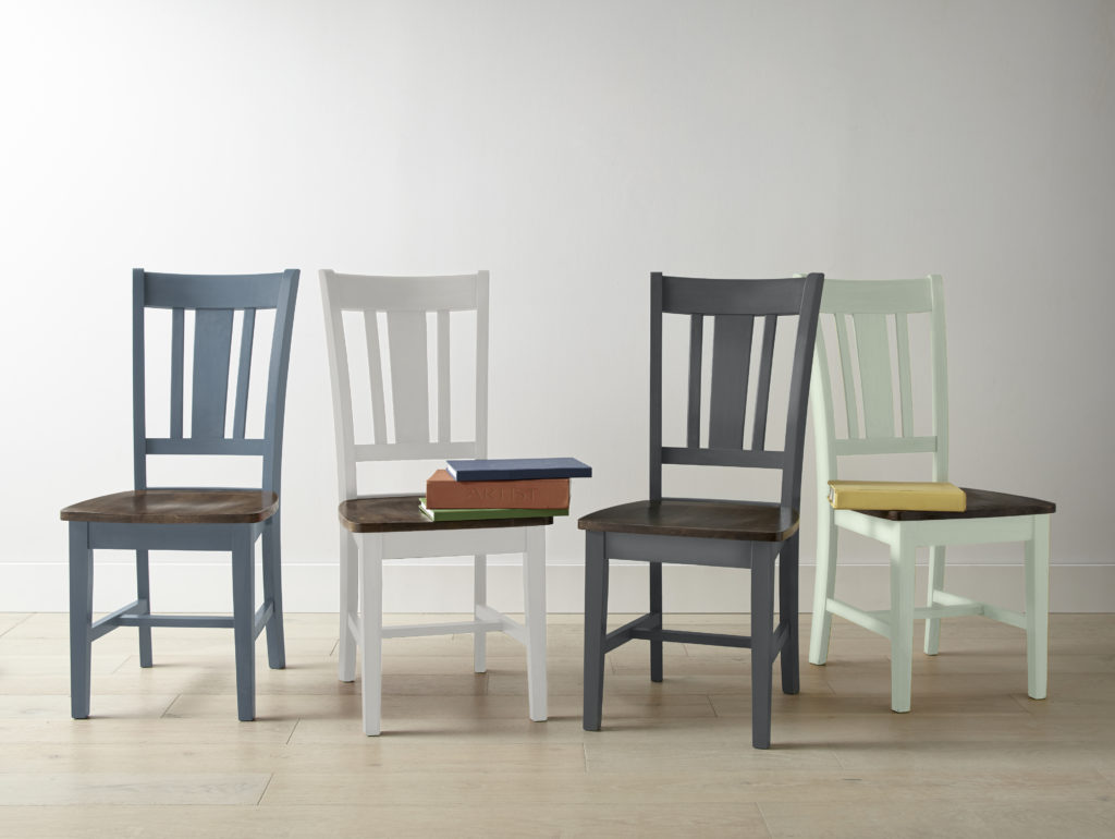 Four chairs, each painted in a different color; blue, white, gray, green hues.